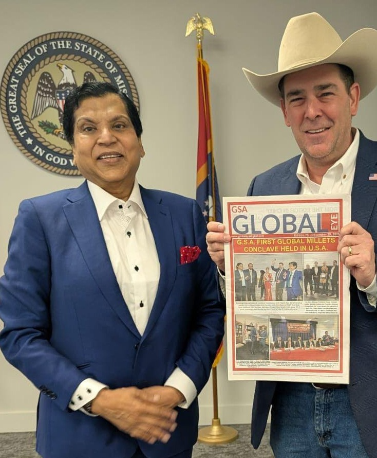 Commissioner Andy Gipson receiving Global Eye Magazine from Dr. VGP